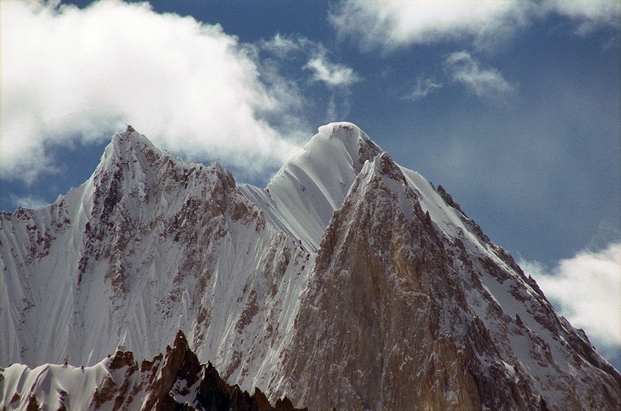 09 Gasherbrum VI Close Up From Upper Baltoro Glacier On The Way To Shagring Camp The summit area of Gasherbrum VI (7003m), also called Chochordin Peak, pokes above an intervening ridge as we trek on the Upper Baltoro Glacier towards Shagring Camp.